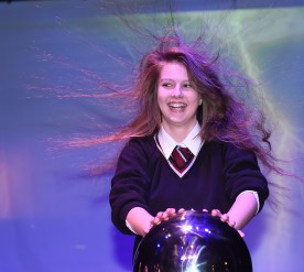 Anna from St Josephs College Cookstown trying out the Van de Graaff Generator