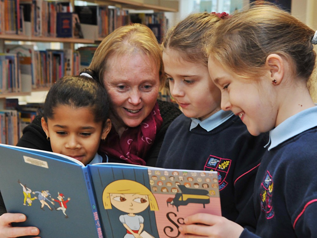 No Reproduction Fee Finnola Browne, Bord Gais, with Sophie Gondo, Shanice Browne and Niamh Daly, pupils from Scoil Aiseiri Chriost Farranree at the "Time to Read" BITCI education programme in the Blackpool Library. Pic John Sheehan Photography